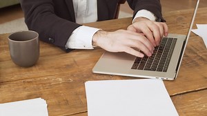 Close up of an unrecognizable businessman's hands typing on laptop computer Free Stock Video Footage