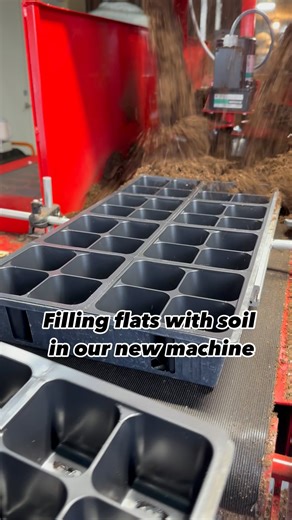 The flat filling machine is getting a workout this spring. With thousands of flats to do, this speeds up the process from how we manually filled the flats over all the years in the past. We are filling flats for planting bedding plants and taking them to the next step to be planted with flower plugs. #greenhouselife #greenhouseadventures #greenhouse #beddingplants #flowers #gardening #landscaping # | Sharkey's Greenhouses