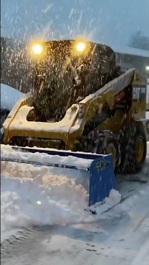 Cat skid steer plowing snow last year during the blizzard of 2022