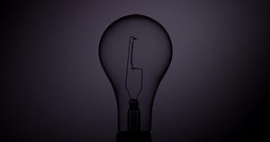 Download Classic light bulb flickering fast with warm vertical filament in 4K for free