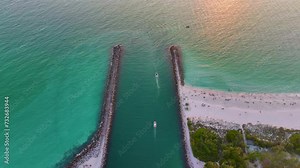 North and South Jetty on Nokomis beach near Venice, Florida. Aerial view of sea shore with white yachts floating on sea waves. Motorboat recreation on ocean surface