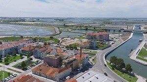 Beautiful aerial view of Aveiro city in Portugal. Aveiro Water canal of Ria de Aveiro with typical boats and tourists, cityscape in the background.