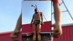 Big John, a giant Indian figure, outside Pratt's BBQ breaks neck