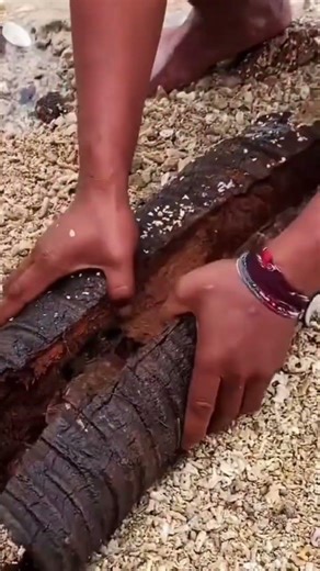 This is a tree trunk that is being split using a sharp cutting tool easily