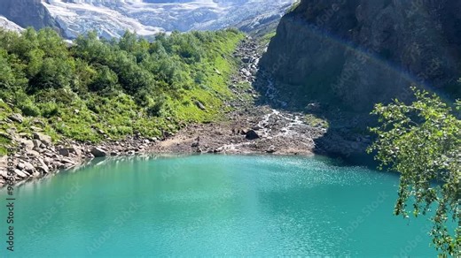 Lake Turye. A beautiful turquoise lake in the Dombay mountains, a summer hike through the national park to Alibek waterfall and glacier. Tourier Lake lake in the Caucasus mountains. Blue glacial water