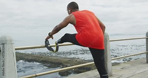 Rear view man with prosthetic leg stretching