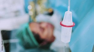 Intravenous Fluid Infusion During Advanced Surgery Inside Operating Room. Surgeon Doing Emergency Surgery. Saline Pump Set Drip to Blood Loss Patient with Blur Background. Medical Concept.