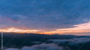 First light in sunrise morning rolling sea of clouds in the mountain, beautifull sky background, time-lapse.