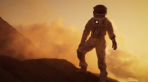 clip-1008373357-silhouette-astronaut-standing-on-rocky-mountain-alien