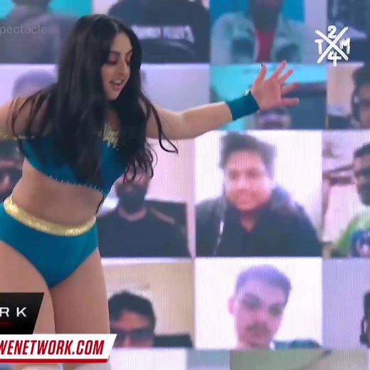 Exciting Women's Wrestling Match: Blue vs Green Attire