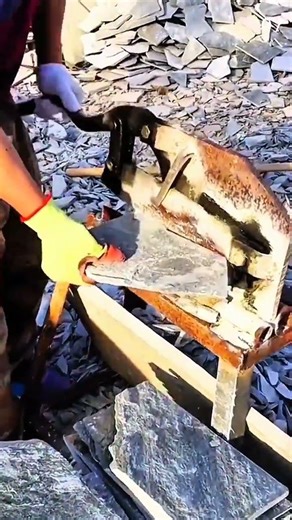 Cutting slate stone manually with lever-operated press