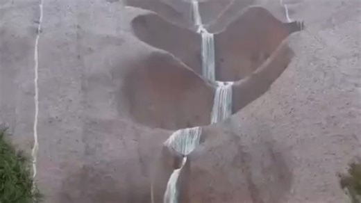 Waterfall forms on Australian natural landmark after heavy rainfall