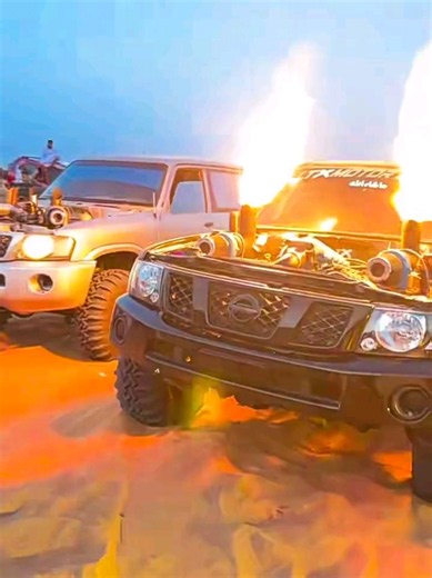 The ultimate desert kings: These Turbo Nissan Patrols are absolute monsters! 🏜️🔥 Don't let the sandy terrain trick you—these custom Nissan Patrols are true beasts on the dunes. With their massive turbo setups delivering relentless power, they can conquer the steepest hills while throwing huge pillars of fire straight out of the hood. Watching these off-road icons shoot flames into the twilight sky is a perfect reminder of why high-horsepower builds remain a favorite among desert enthusiasts! �