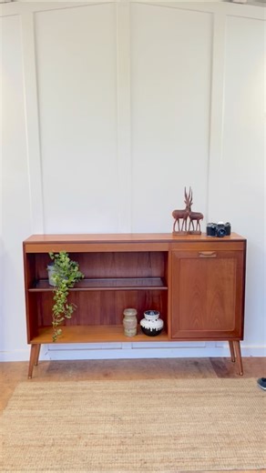 Vintage Lounge Furniture on Instagram: "Available! This stunning teak G Plan Fresco sideboard is new in stock! A blend of warm teak and afromosia woods. 🤎 The sideboard boasts open shelving and drop down cocktail cabinet! 🍸 Key features: - Two height adjustable shelves - Turned wooden legs - Wooden handle - Drop down cocktail hatch The woodwork had been finished in Osmo hardwax oil. Dimensions: Width 136.5cm Depth 28cm Height 90cm £295 Nationwide delivery can be arranged, please message for a 