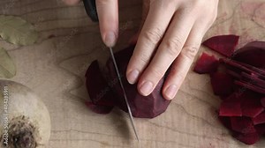 Preparation of beet kvass - cutting fresh beetroot with a knife, top view