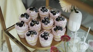 Candy Bar Wedding, candy buffet, tasty dessert with blueberries, delicious Candy bar at a wedding, candy bar decorated with flowers slow motion