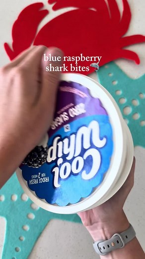 Blue Raspberry Shark Bites🦈 To celebrate the 50th anniversary of the movie Jaws🎬, you’ll have to take a bite out of these delicious treats! Instructions: * Add half a box of blue raspberry jello to a container of cool whip. Mix until combined. * Line a baking sheet with parchment paper and place spoonfuls of the mixture onto the paper. * Add dried strawberry crumbs to each mixture to look like blood. * Put into the freezer for at least 2 hours. * Add a gummy shark and they are ready to eat! #s