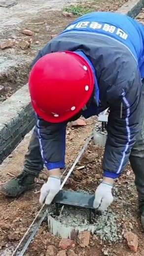 Installing an iron support bar to strengthen the pole structure before cement is poured properly.