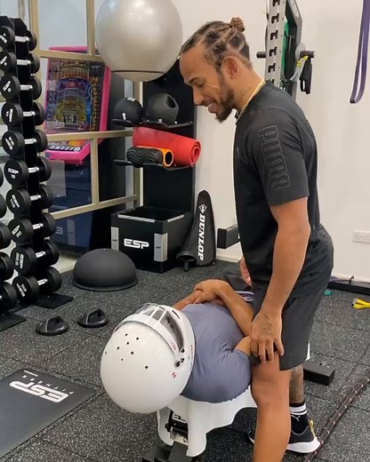 Lewis Hamilton helping his brother Nicolas, who has cerebral palsy, with weighted helmet neck exercises 💪 (via nicolashamilton/Instagram) | ESPN F1