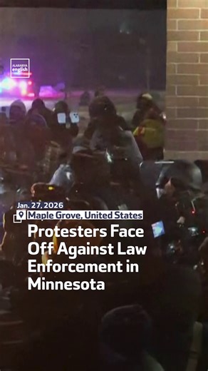 Protesters face off against law enforcement officers in Maple Grove, Minnesota, during a demonstration against the presence of federal agents deployed by US President Donald Trump to combat immigration. | Al Arabiya English
