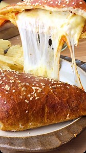 Imported Munster cheese is the star of this Pretzel Stromboli. An Italian/German fusion recipe made with tangy and creamy imported Munster rolled in a crunchy pretzel crust with ham & cornichons. i🇮🇹🇩🇪 Get the recipe at the link in our bio or here: https://iloveimportedcheese.com/recipe/4782/ #cheeserecipes #cheese #cheeselover #food #foodie #sandwich | I Love Imported Cheese