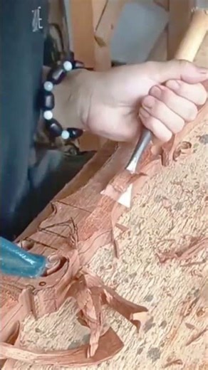 Precision hand carving shaping detailed wooden relief surface carefully