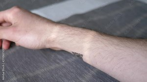 Showing a QR Code tattoo on a wrist of a person. Technology and the human body concept.