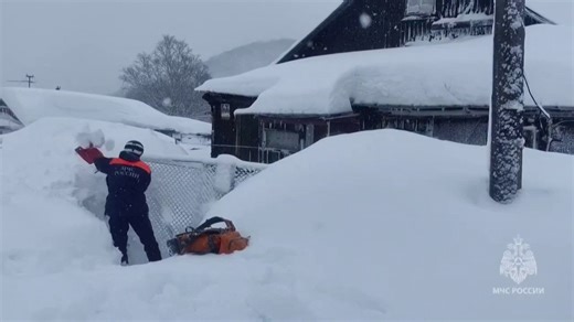 Entire buildings buried in huge snow drifts as mega blizzards kill at least 2
