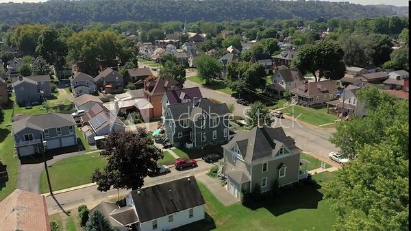 A slowly orbiting summer aerial establishing shot of a typical Western Pennsylvania upscale residential neighborhood. Pittsburgh suburbs.