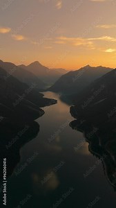 Breathtaking aerial view of Lake Plansee, nestled in the Tyrolean mountains of Austria during a golden sunset.