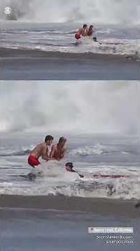 Teen lifeguard saves child from being swept away by massive waves #shorts