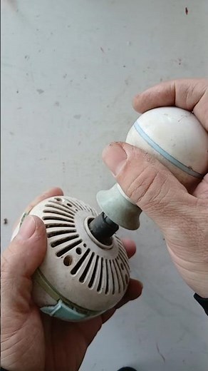 Discovering the inner workings of a broken mini ceiling fan found in a pile of old items.