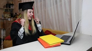 Virtual graduation and convocation ceremony. Excited student wearing graduation gown and cap talking with her family and receiving congratulation during online video call, distant education