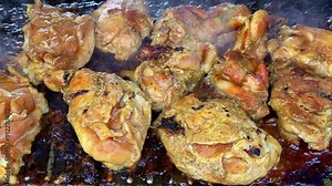 Grilled chicken meat over on open grill. Grilled chicken that emits smoke