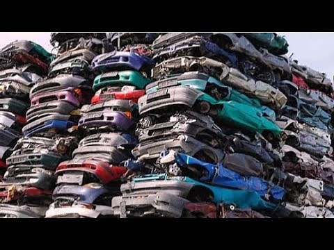 End-of-Life Cars Recycling Process With Car Shredder and Crushing Machines.