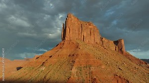 Aerial imagery above Moab desert scene with rocky outcrops and Mesa in 4K