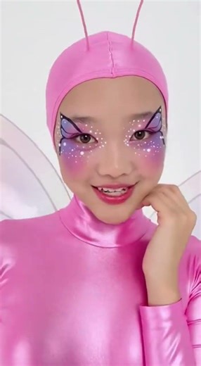 A teenager girl wears a pretty butterfly lycra spandex costume.