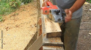 carpenter worker's power tool while planing a piece of wood