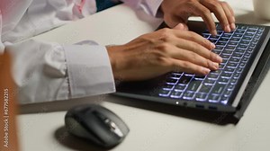 Close up shot of businessman using laptop in office to write emails. Employee typing on notepad keyboard, composing documents in order to deliver finalized project paperwork to management