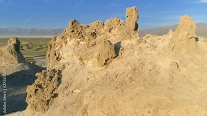 TRONA PINNACLES, CALIFORNIA, USA. Aerial 4K shot of the mysterious Trona Pinnacles. The collection of massive stone spires in the middle of the flat, dusty, hot desert.