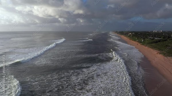 An aerial view over the ocean off Boynton Beach, Florida on a cloudy day. The drone camera dolly in over the white waves, the day after hurricane Milton, it was still windy.