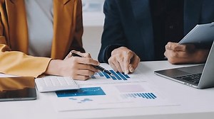 Audit concept,Administrator business man financial inspector and secretary making report calculating balance. Internal Revenue Service checking document.