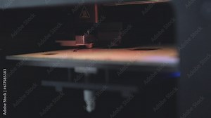 A close up shot of a 3D printer printing a desing on a PEI sheet on a printer bed