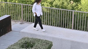 Woman walking in a park enjoying nature on a sunny day