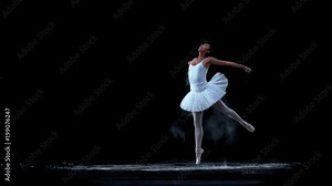 Ballerina performing on black background spinning slow motion