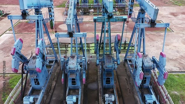 Working Pumpjack industrial oil pump jack working and pumping crude oil for fossil fuel energy at oil and gas a land rig onshore drilling rig