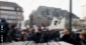 Tilt-up from protection fences to large crowd of protestors during a nationwide demonstrations against politics social movements Out-of-Focus