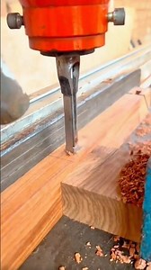 Drill press using a square mortising bit to cut a clean, rectangular hole into wood