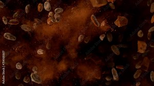 Super slow motion of pieces of chocolate chunks and raw cocoa beans exploding. Top view. Filmed on high speed cinematic camera at 1000 fps.
