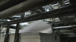 Old vintage printing press is working draws paper in printing factory